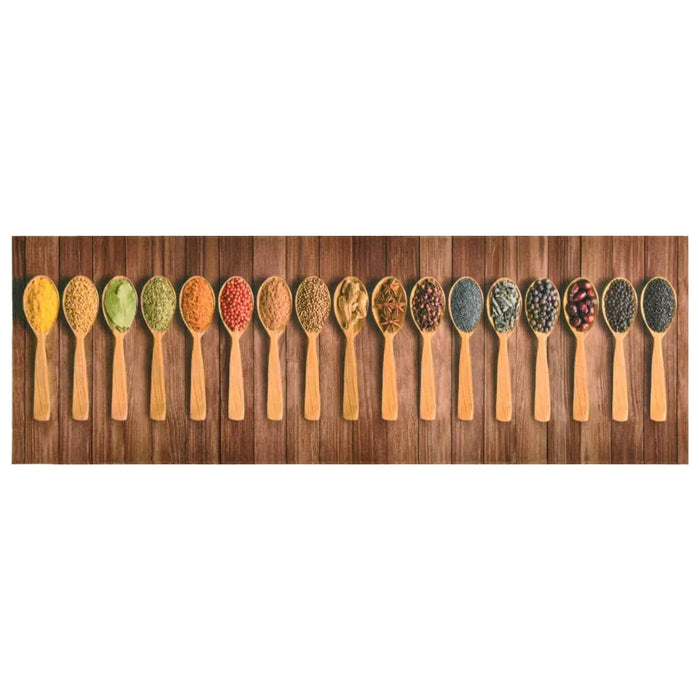 Row of wooden spoons with various colorful spices and herbs on wooden surface