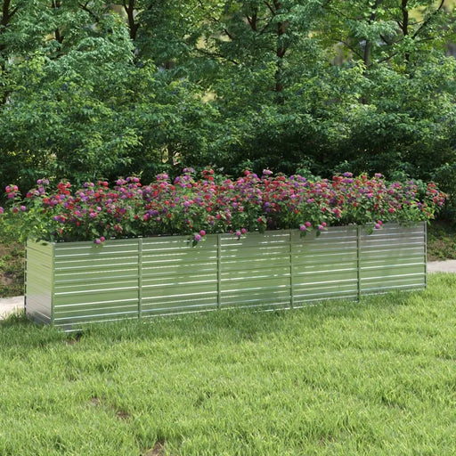 Rectangular galvanised steel garden raised bed with colorful flowers on a grassy lawn