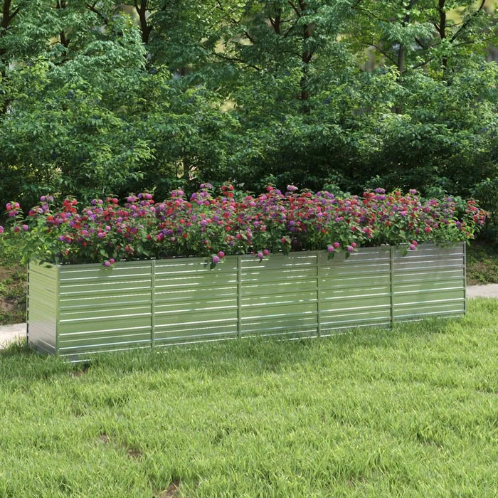 Rectangular galvanised steel garden raised bed with colorful flowers on a grassy lawn