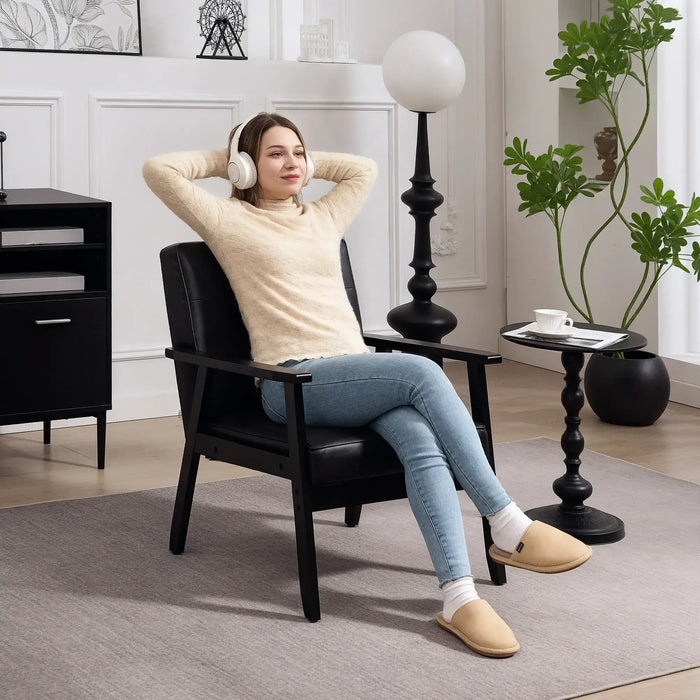 Woman sitting in a black chair wearing headphones in a modern living room.