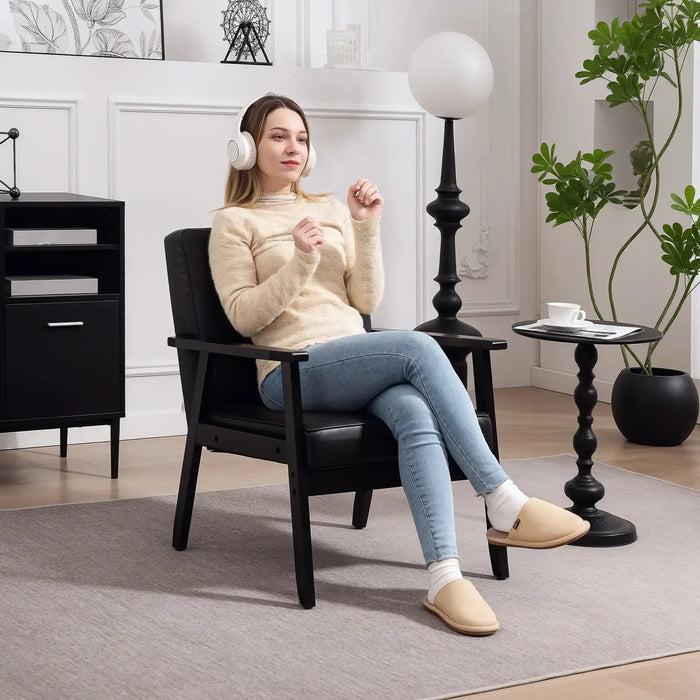Woman sitting in a black chair wearing headphones in a modern living room.