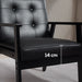 Black leather armchair with a measurement label on the seat