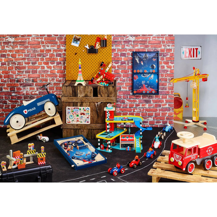 Retro police ride-on car and classic metal toddler toys in colorful playroom with brick wall décor