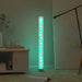 16 colour LED RGB floor lamp with retro clear tube design glowing in a modern living room