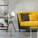 Yellow sofa with decorative pillows in a modern living room setting.