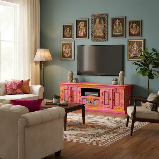 Living room with retro pink wooden TV cabinet featuring hand-painted floral design, beige sofas, and ethnic wall art