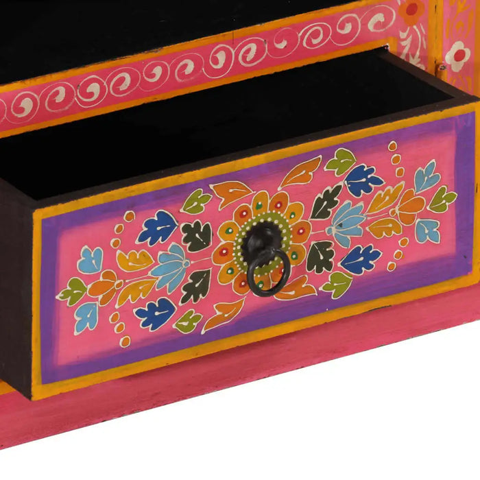 Close-up of a retro wooden TV cabinet drawer with pink and mango wood finish and hand-painted colorful floral design