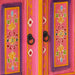 Close-up of retro wooden TV cabinet with hand-painted floral designs in pink, purple, and yellow