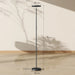 Black floor lamp with dimensions indicated on a neutral background