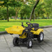 Yellow ride-on excavator toy with metal frame and steering wheel on paved outdoor path