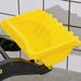Yellow plastic excavator bucket on black metal arm, tiled wall background