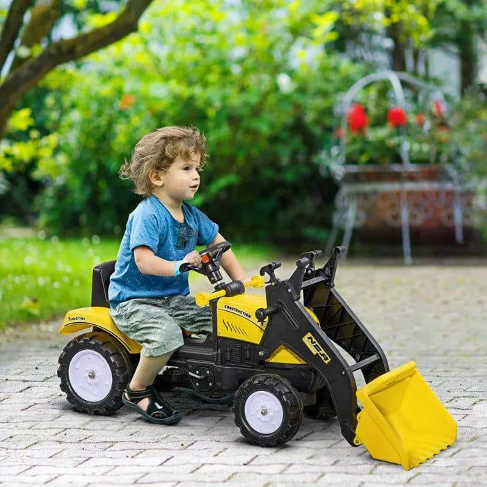 Child riding yellow ride-on excavator toy with metal frame and steering wheel outdoors