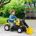 Child riding yellow ride-on excavator toy with metal frame and steering wheel outdoors