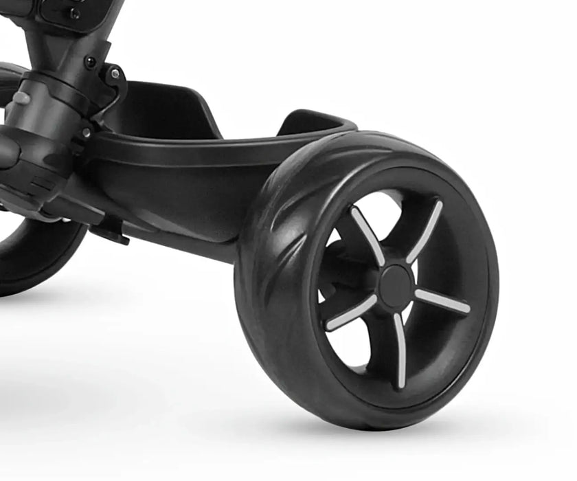 Close-up of a black tricycle wheel on a white background