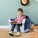 Child reading on a multicolour rocket kids armchair in a cozy playroom
