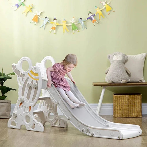 Child on grey rocket-themed toddler slide with non-slip steps in playroom