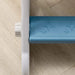 Close-up of blue rocket-themed toddler slide step with star patterns on light wood floor