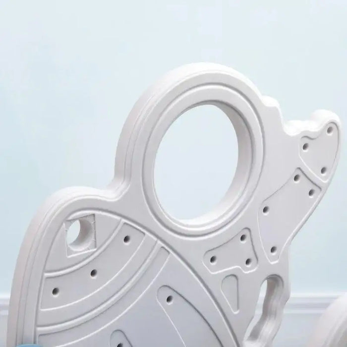 Close-up of blue rocket-themed toddler slide panel with circular window design, indoor setting