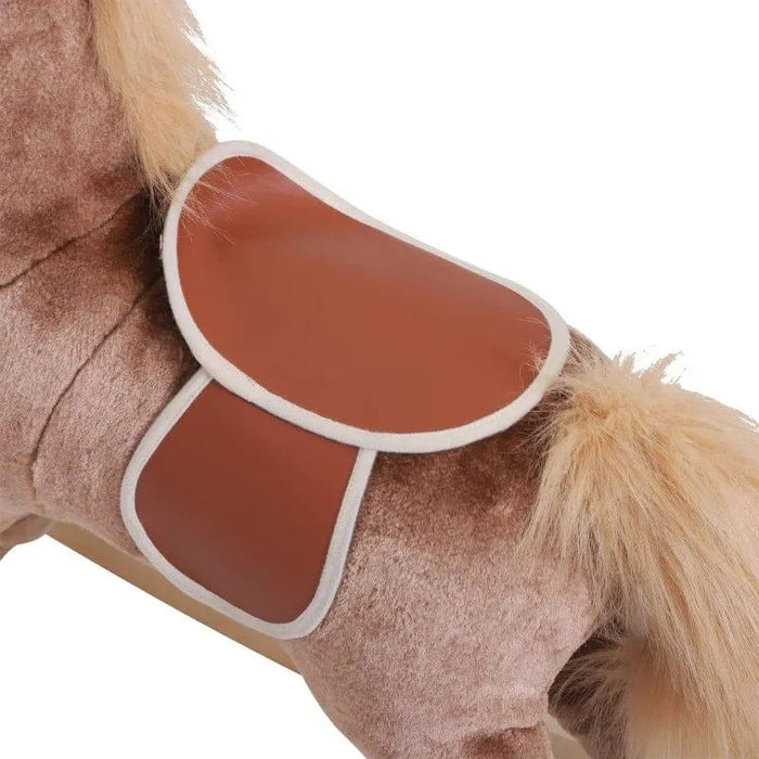 Close-up of brown plush rocking horse with faux leather saddle and fluffy tail