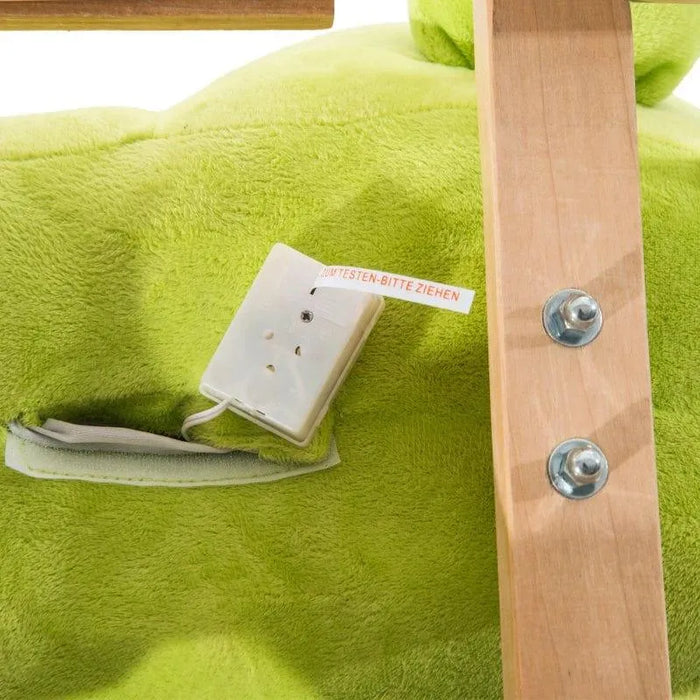 Close-up of green plush rocking horse with wood frame and battery compartment.