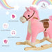 Pink and white rocking horse toy with brown saddle on wooden base, rainbow background
