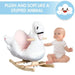 Baby next to plush white swan rocking horse with wooden base and pink seat