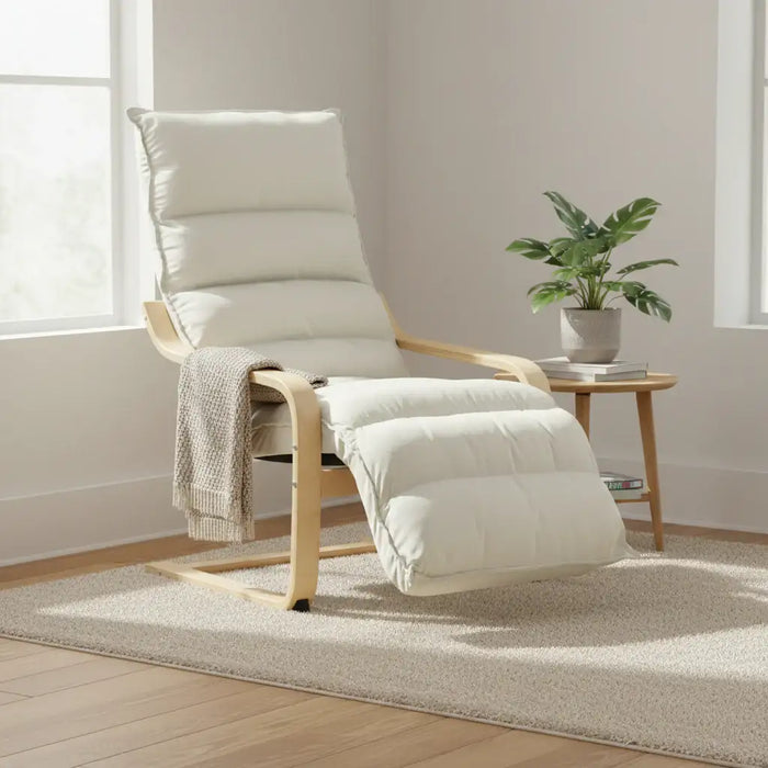 Beige recliner chair with footrest in a room with a plant and small table.