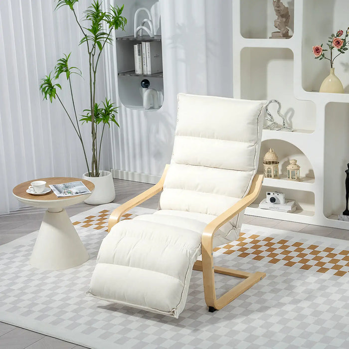 White recliner chair in a modern living room with a small table and decorative items.