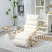 White recliner chair in a modern living room with a small table and decorative items.