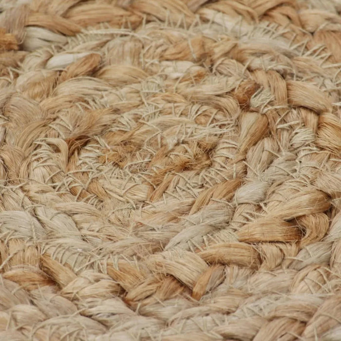 Close-up of a woven natural fiber mat with a braided pattern.