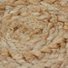 Close-up of a woven natural fiber mat with a braided pattern.