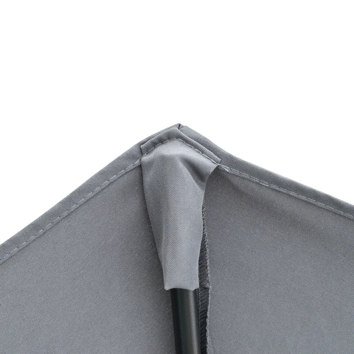 Close-up of a gray fabric corner with stitching detail on a white background