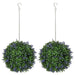 Two artificial hanging plant balls with green leaves and purple flowers on a white background