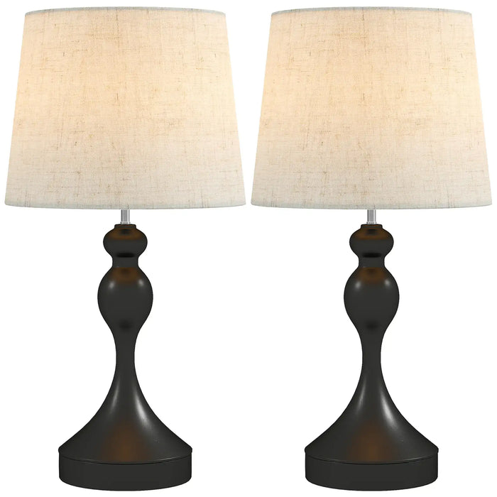 Two table lamps with black bases and white lampshades on a white background
