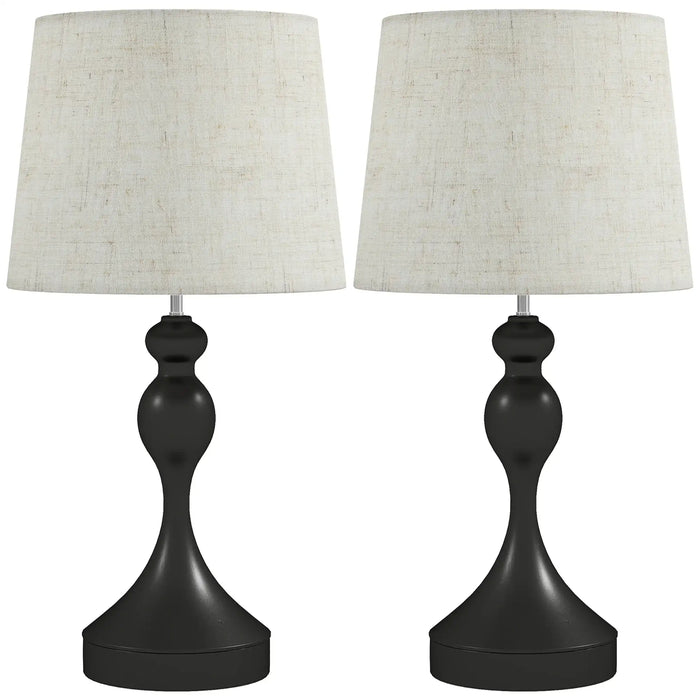 Two table lamps with black bases and white lampshades on a white background