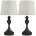Two table lamps with black bases and white lampshades on a white background