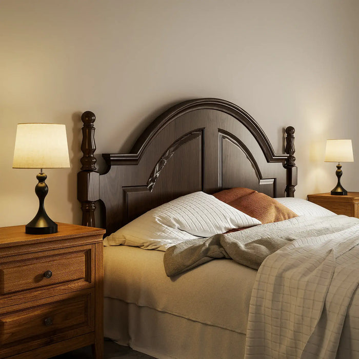 Bedroom with wooden headboard, nightstands, and lamps.