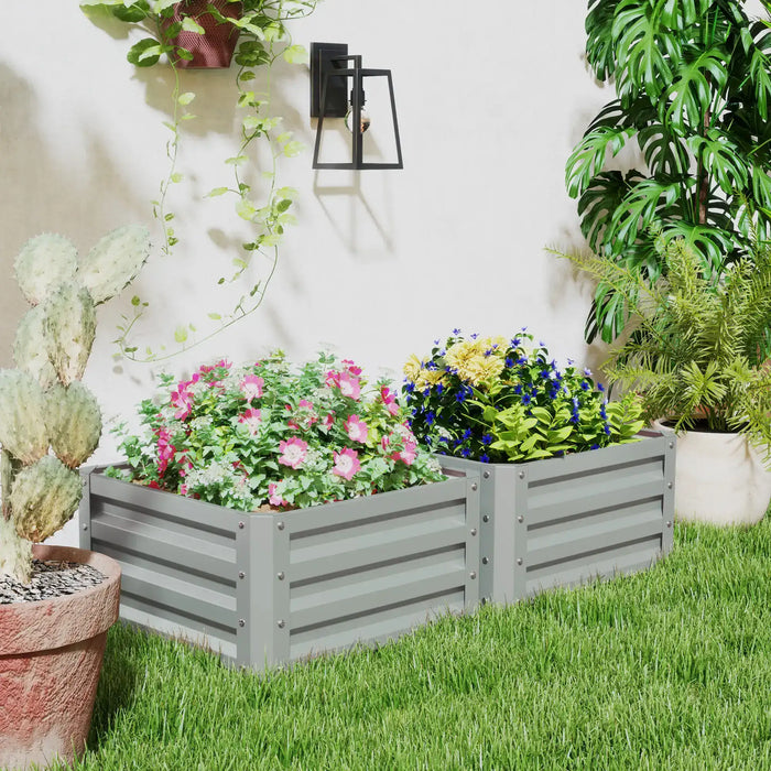 Gray metal raised garden beds with colorful flowering plants in a sunny backyard garden