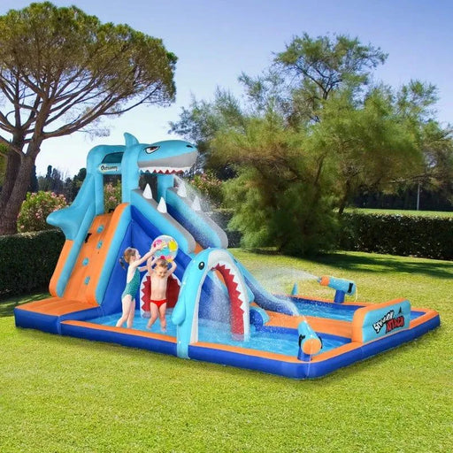 Shark-themed inflatable water park with slide, climbing wall, pool, and water gun outdoors