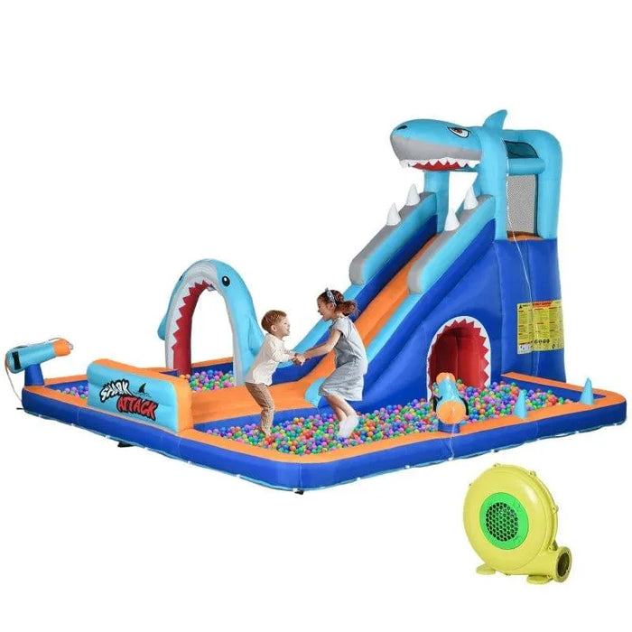 Shark-themed inflatable water park with slide, climbing wall, pool, and kids playing