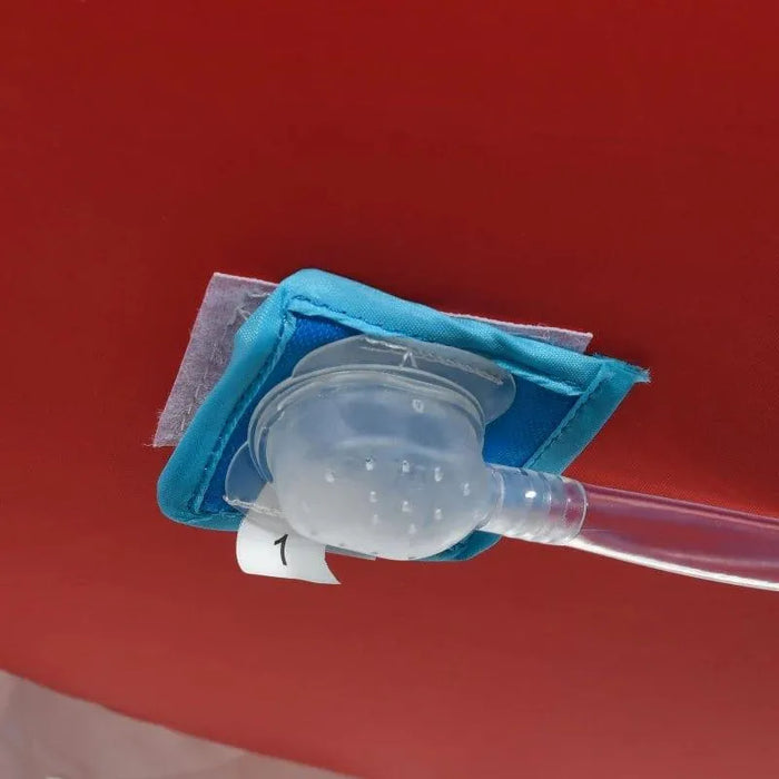 Close-up of an inflatable water park air valve on red material with a blue fabric patch.