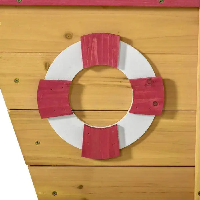 Wood ship sandbox detail with red and white life ring decoration, outdoor kids playset