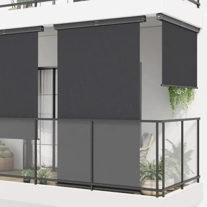 Black side awning installed on modern balcony with glass railing and potted plants