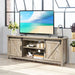 Sliding barn door TV stand with storage shelving, rustic farmhouse media console holding a 60-inch TV