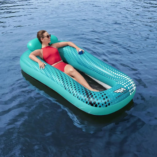 Woman relaxing on turquoise mesh floating lounger with cup holder in lake