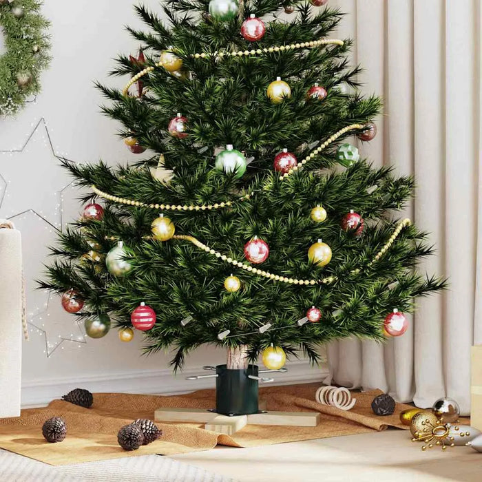 Decorated Christmas tree with red, gold, and green baubles and gold bead garland in cozy living room