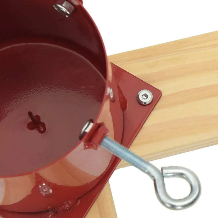 Close-up of red metal tree stand base attached to wooden cross with metal screw and bolt