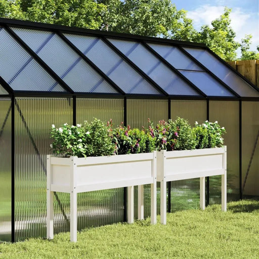 Solid pine wood garden planter set of two with flowers outside a greenhouse on grass