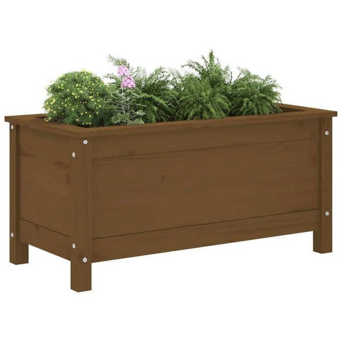 Solid pinewood garden planter in honey brown with green plants and flowers