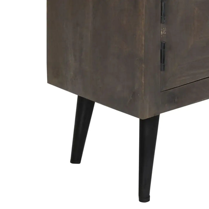 Close-up of dark wooden cabinet with tapered black metal legs, modern storage furniture detail